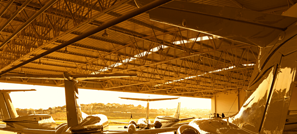 Aircraft in a hangar at sunset